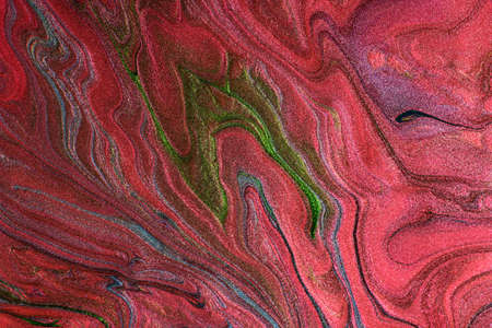 Beautiful shimmer stains of liquid nail polish.Red, green and blue colors.Stripy paint texture.Nail lacquer flow background in fluid art technique.Minimalism concept.Copy space, horizontal photography.の写真素材