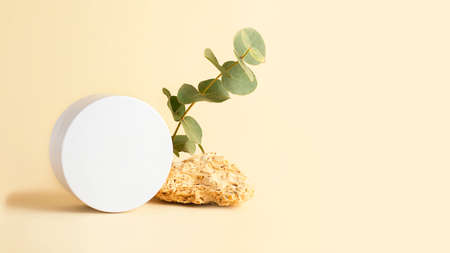 Composition from the natural materials and round cosmetics box near it.Copy space for text or design.Can be used as advertising large banner.Pastel colors.の写真素材