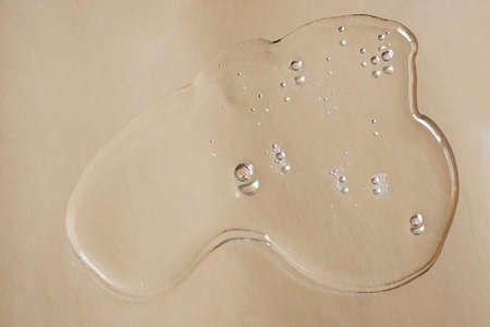 Swatch of liquid transparent gel on silver metallic background.Bubbly structure, cosmetics banner.の写真素材
