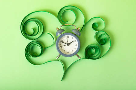 Human brain made from paper and alarm clock in it.COncept of the healthy sleaping and circadian rhythms.の写真素材