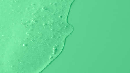 Background from cosmetic gel with bubbles, dripping down.Copy space for text or design.Top view, antibacterial liquid surface.Good as background or mockup.の写真素材