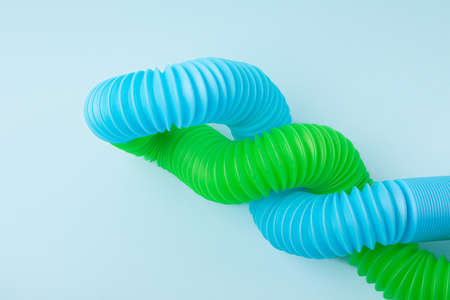 Closeup photography of composition from multicolored curved pop tubes with negative space.Trendy antistress toy for children.の写真素材