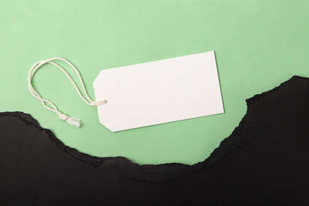 Torned paper on the green background with blank label on it, concept of green friday and black friday.の写真素材