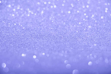 Defocused trendy violet glittering background with shinig bokeh.の写真素材