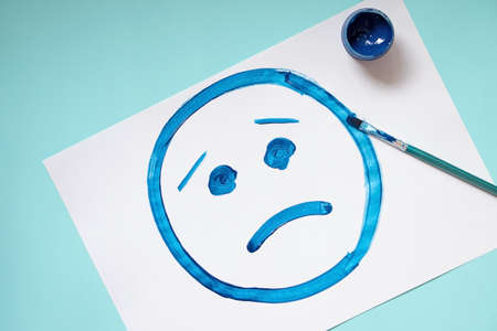 Top view of the paper with drawing sad face.Blue monday and mental health concept.の写真素材