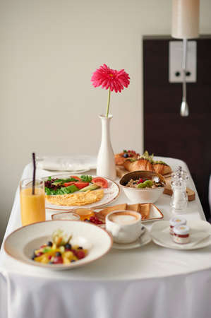 Vertical photography of served table-fresh bakery,croissants,fruit salad,coffee.の写真素材