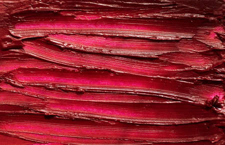 Abstract red smear of glossy lipstick,macro photography of texture.