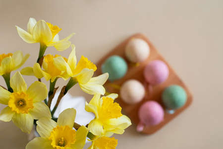 Top view of spring flowers with easter eggs on background.