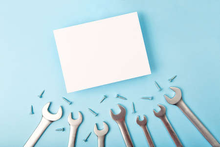 Top view of white greeting card with wrench around it.Fathers day concept,good for mans offer.