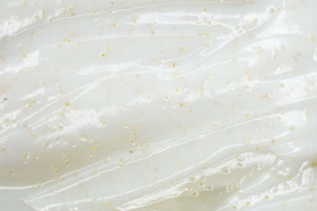 Texture of face scrub on yellow background.
