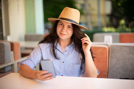 Smiling woman making selfie outside.の写真素材