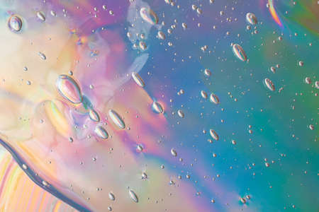 Abstract cosmetics gel on holographic background.Good as cosmetic banner.の写真素材