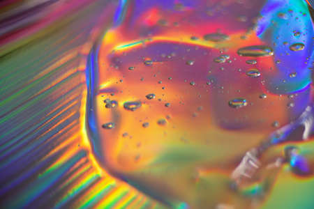 Abstract cosmetics gel on holographic background.Good as cosmetic banner.の写真素材