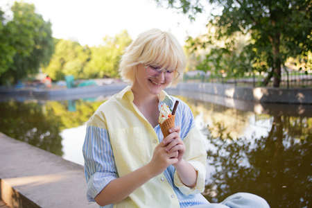 Happy teenage girl in the park with ice cream.の写真素材