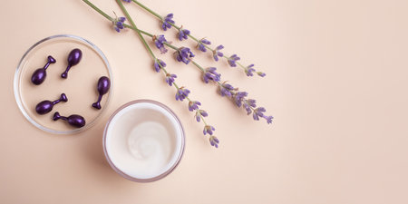Top view of open container with cream and cosmetics capsules in petri dish near it.Large banner with negative space.の写真素材