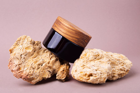 Eco friendly cream container with wooden cover on the natural stones.Good as cosmetics mockup.の写真素材