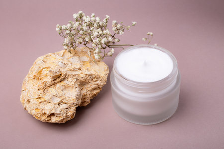 Top view of open cosmetics container with white cream in it.Pastel colors,good as mockup.の写真素材
