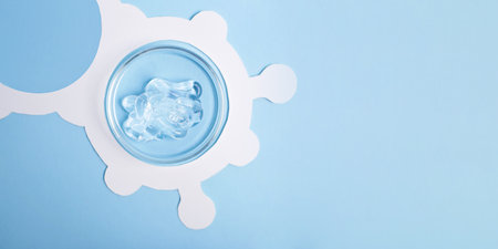 Top view of petri dish with cosmetics gel swatch in it.White molecule structure around,large banner.の写真素材