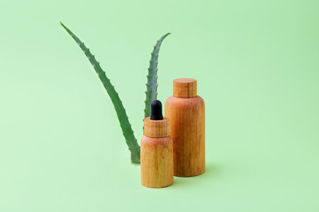 Wooden cosmetics containers with aloe vera on background.Organic cosmetic concept.の写真素材
