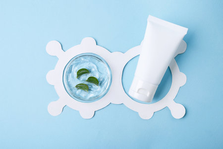 Top view of petri dish with aloe vera slices in it and cosmetics tube.White molecule structure around.の写真素材