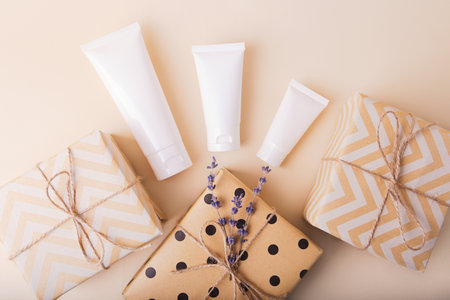 Top view of blank cosmetics tube with gift boxes near it.Festive concept.の写真素材