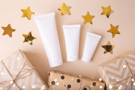 Top view of blank cosmetics tube with gift boxes near it.Festive concept.の写真素材