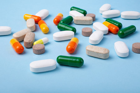 Front view of different pills on blue background,copy space for text.Large banner with negative space.の写真素材