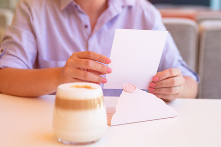 Closeup photography of woman with certificate gift and wax seal.Sunlight on background.の写真素材
