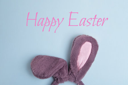 Top view of fluffy bunny rabbit ears on blue background. Happy Easter minimal concept.の写真素材