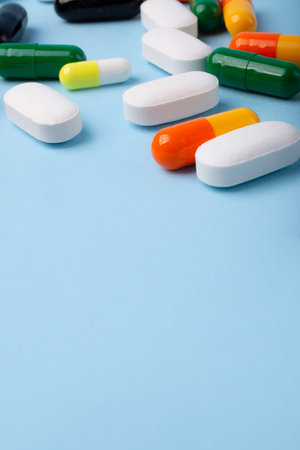 Front view of different pills on blue background,vertical banner with negative space.の写真素材