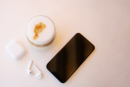Top view from coffee cup,headphones and smartphone.Background with copy space.