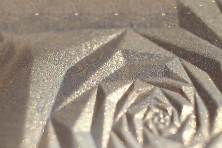 Macro photography of the cosmetic highlighter powder with shimmer.