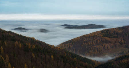 Autumn fog under the top of the mountain
