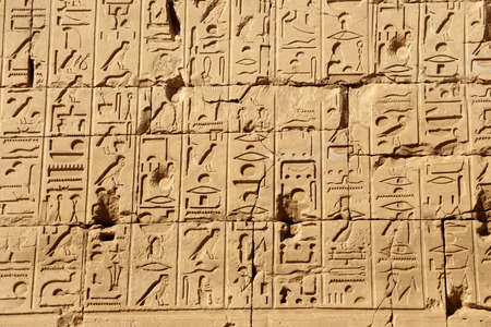 Egyptian symbols on the wall of ancient temple in Luxor