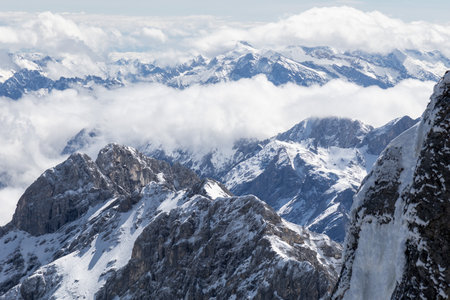 Panoramic view of snow-capped mountains from the Zugspitze peak in the Alpsの写真素材