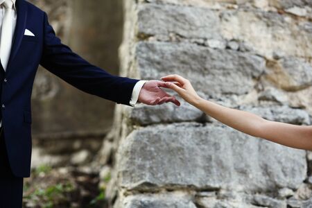 the groom holds the hand of a brideの写真素材