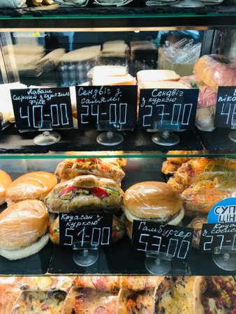 Variety of sandwiches and pastries displayed for customersの写真素材