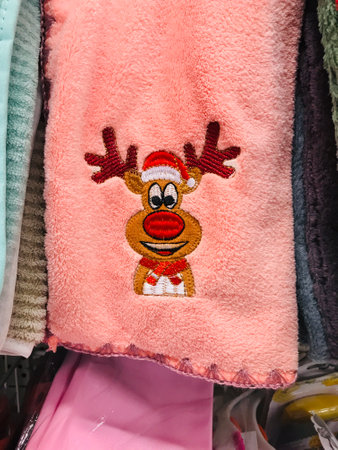 Colorful towel featuring a reindeer design hangs in store.の写真素材