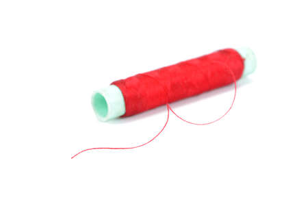 Needle and thread isolated over white backgroundの写真素材