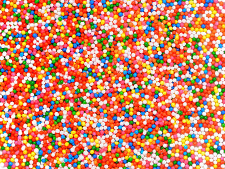 Background of colorful sprinkles, jimmies for cake decoration or ice cream toppingの写真素材