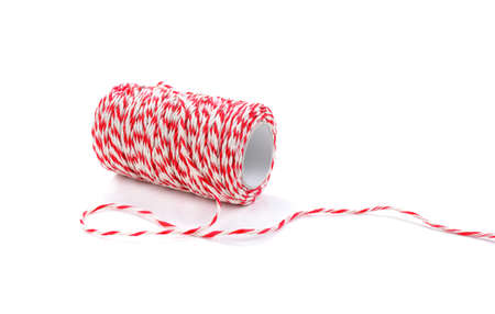 Red and white baker's twine spool isolated on white background