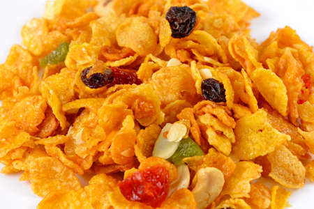 Healthy corn flakes mixed with dried cranberries and black raisins