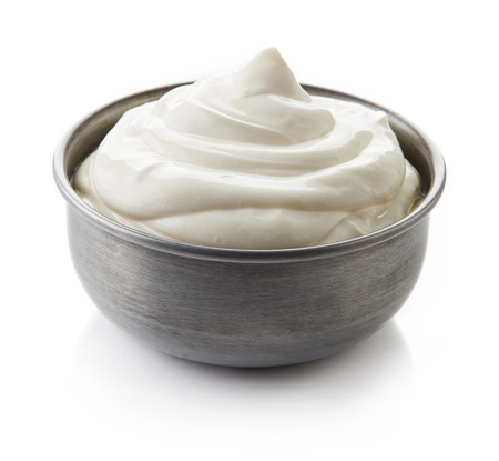 Bowl of cream on white background