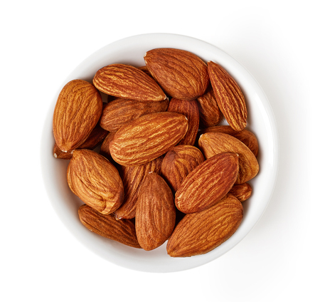 Bowl of roasted almonds isolated on white background, top viewの写真素材