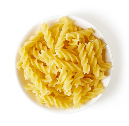 spiral pasta in bowl, isolated on white background, top viewの写真素材
