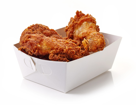 Fried breaded chicken in white cardboard box isolated on white backgroundの写真素材
