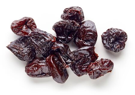 Heap of prunes isolated on white background, top viewの写真素材