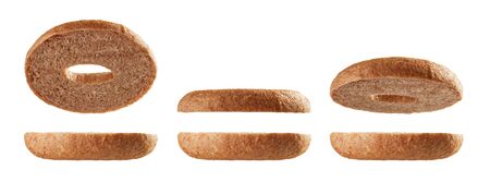 Halved fullgrain bagels levitating in different positions isolated on white backgroundの写真素材