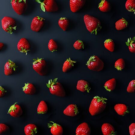 Pattern of fresh strawberries on black background, top viewの写真素材