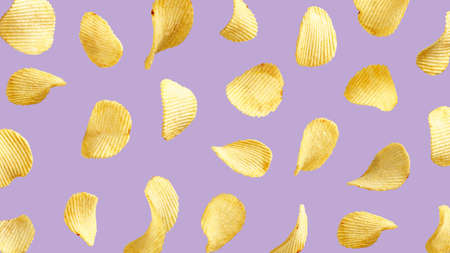 Wavy potato chips flying in the air on purple background